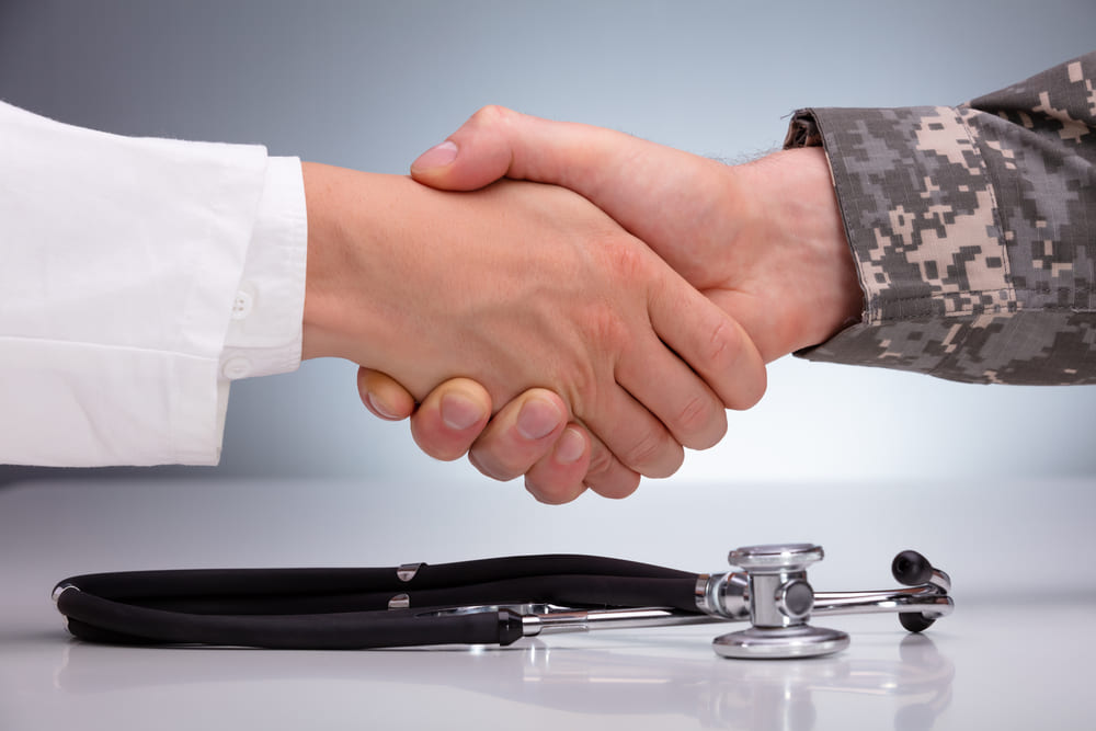 A doctor and a soldier shaking hands